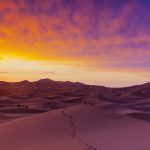 sand dunes illuminated at sunrise, erg chebbi, sahara desert, morocco